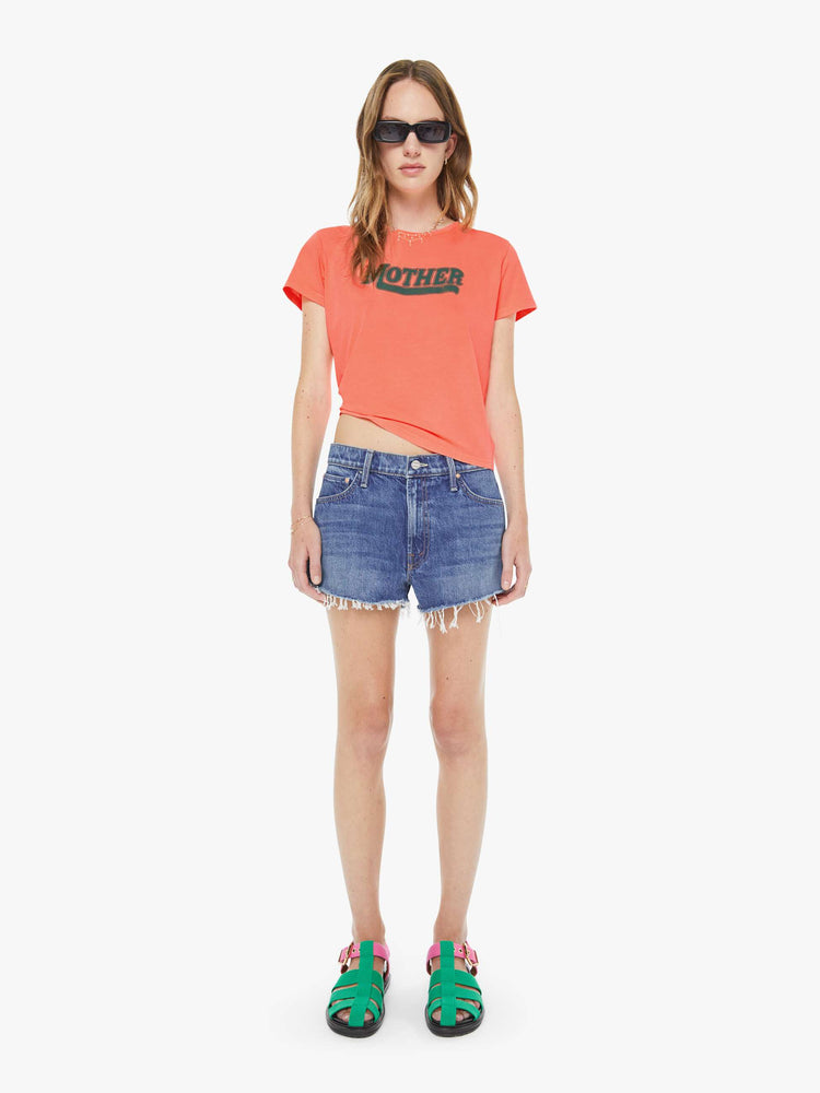 Back view of a woman in a neon orange tee features MOTHER's name in green on the front. 