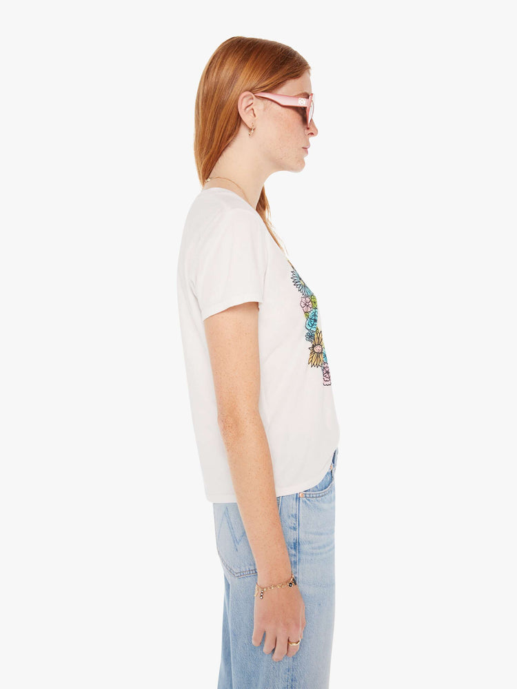 Side view of a white crew neck tee featuring a peace sign made of flowers.