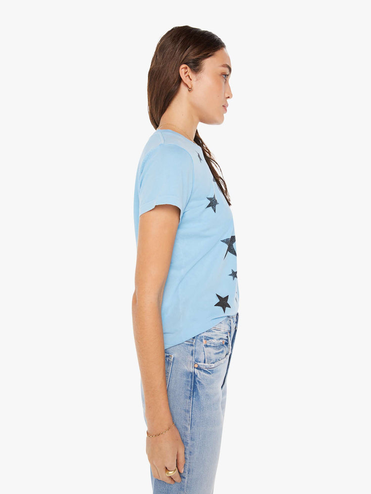 Side view of a woman crewneck in baby blue with faded black stars throughout.