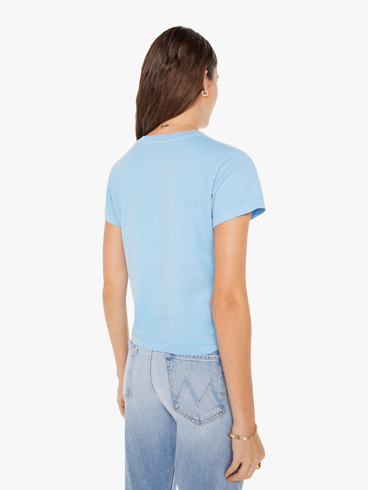 Back view of a woman crewneck in baby blue with faded black stars throughout.