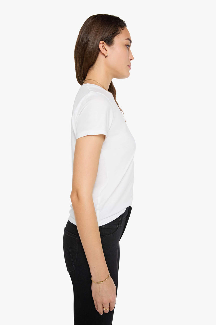 Side view of a woman wearing a fitted white crew neck tee, paired with a black wash jean.