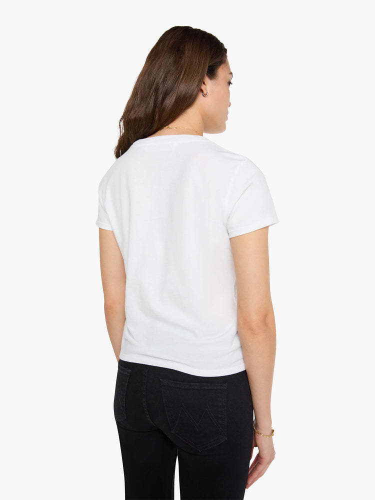 Back view of a woman wearing a fitted white crew neck tee, paired with a black wash jean.