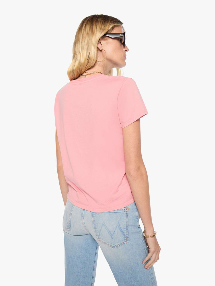 Back view of woman in baby pink tee features a faded black graphic of a dog in a racecar with text on the front.
