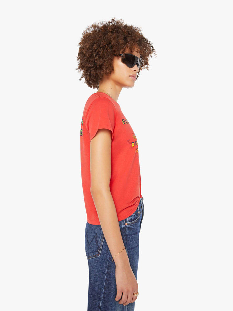 Side view of a woman in a red tee features block text on the front and back.