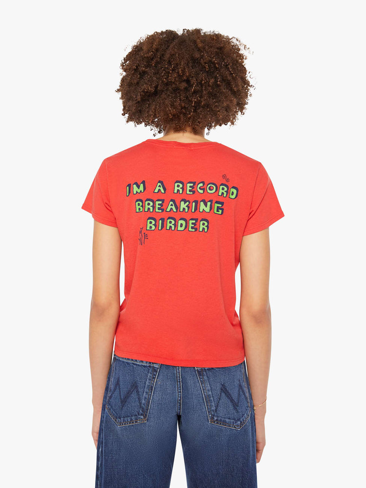 Back view of a woman in a red tee features block text on the front and back.