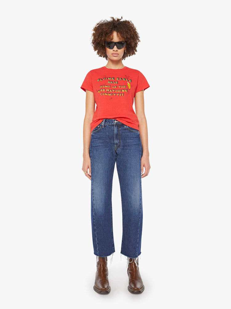 Full body view of a woman in a red tee features block text on the front and back.