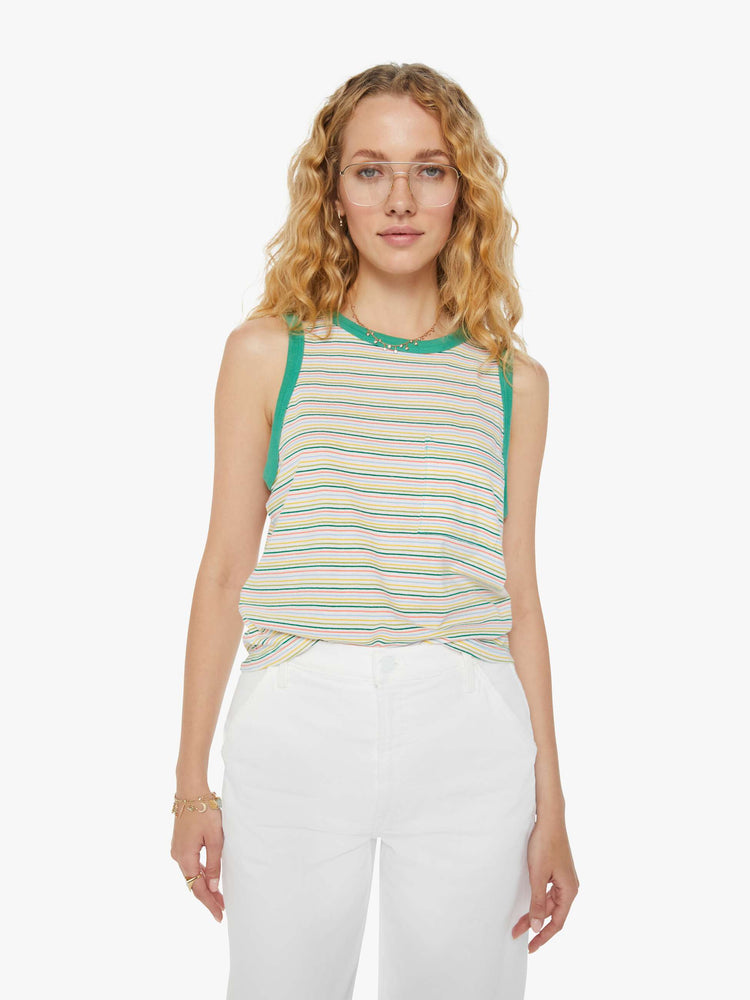 Front view of a woman in a green multi-colored horizontal striped cropped muscle tee with a crewneck, patch pocket and boxy fit.