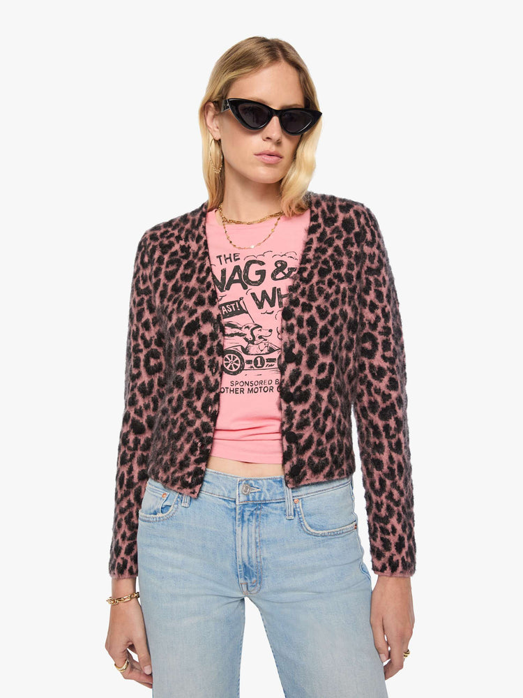 Front view of a woman in a pink and black cheetah print with a brushed finish V-neck cardigan with a cropped hem and buttons down the front.