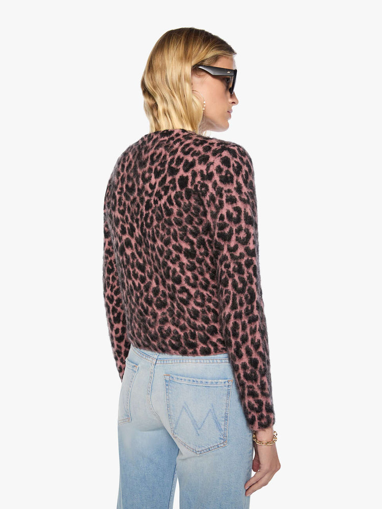 Back view of a woman in a pink and black cheetah print with a brushed finish V-neck cardigan with a cropped hem and buttons down the front.