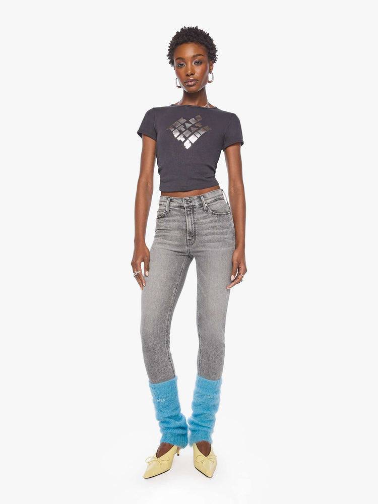 Full body view of a woman in a legwarmer designed in a  bright light blue mohair blend with ribbed hems and MOTHER FUCKER in white across the front.