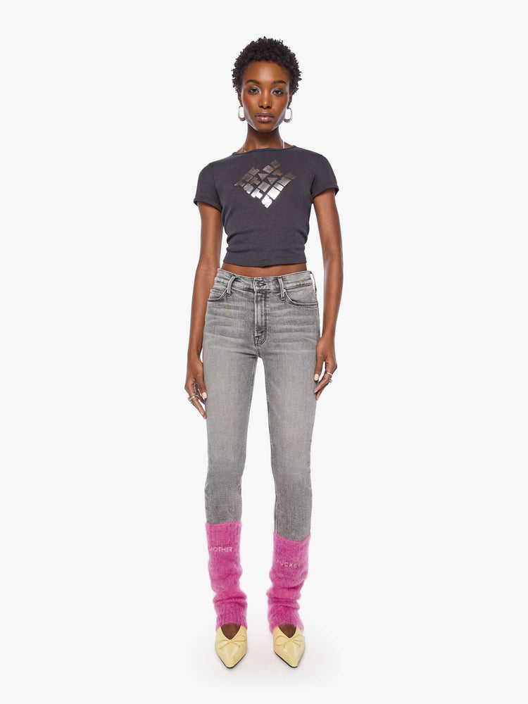 Full body view of a woman in a legwarmer designed in a hot pink mohair blend with ribbed hems and MOTHER FUCKER in white across the front.
