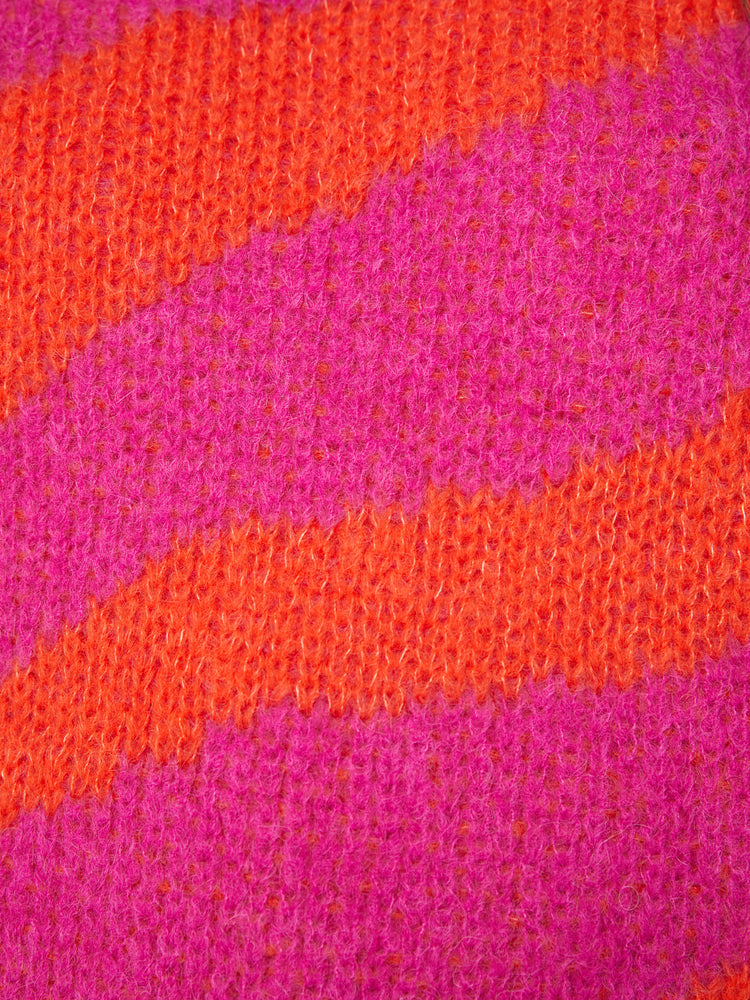 Swatch view of a woman oversized crewneck sweater with drop shoulders, long roomy sleeves and a hip-length hem in bright red and hot pink oversized zebra print.