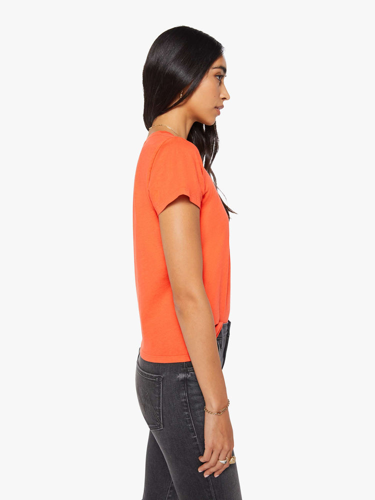 Side view of a woman in a bright orange crewneck with a slim fit for a vintage look and feel.