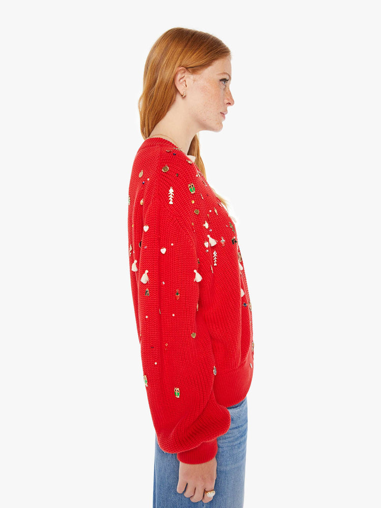 Side view of a woman red with colorful charms, beads and tassels V-neck cardigan with long balloon sleeves, drop shoulders and ribbed hems.