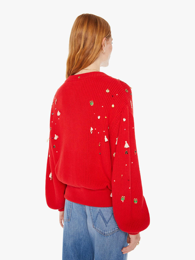 Back view of a woman red with colorful charms, beads and tassels V-neck cardigan with long balloon sleeves, drop shoulders and ribbed hems.