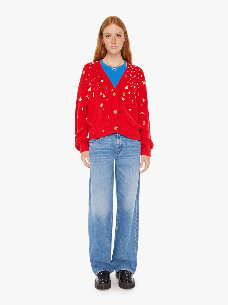 Full body view of a woman red with colorful charms, beads and tassels V-neck cardigan with long balloon sleeves, drop shoulders and ribbed hems.