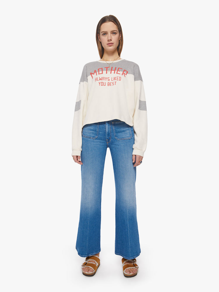 Full body view of an off-white and grey details crewneck pullover with drop shoulders, long loose sleeves, a slightly cropped hem and a boxy fit.