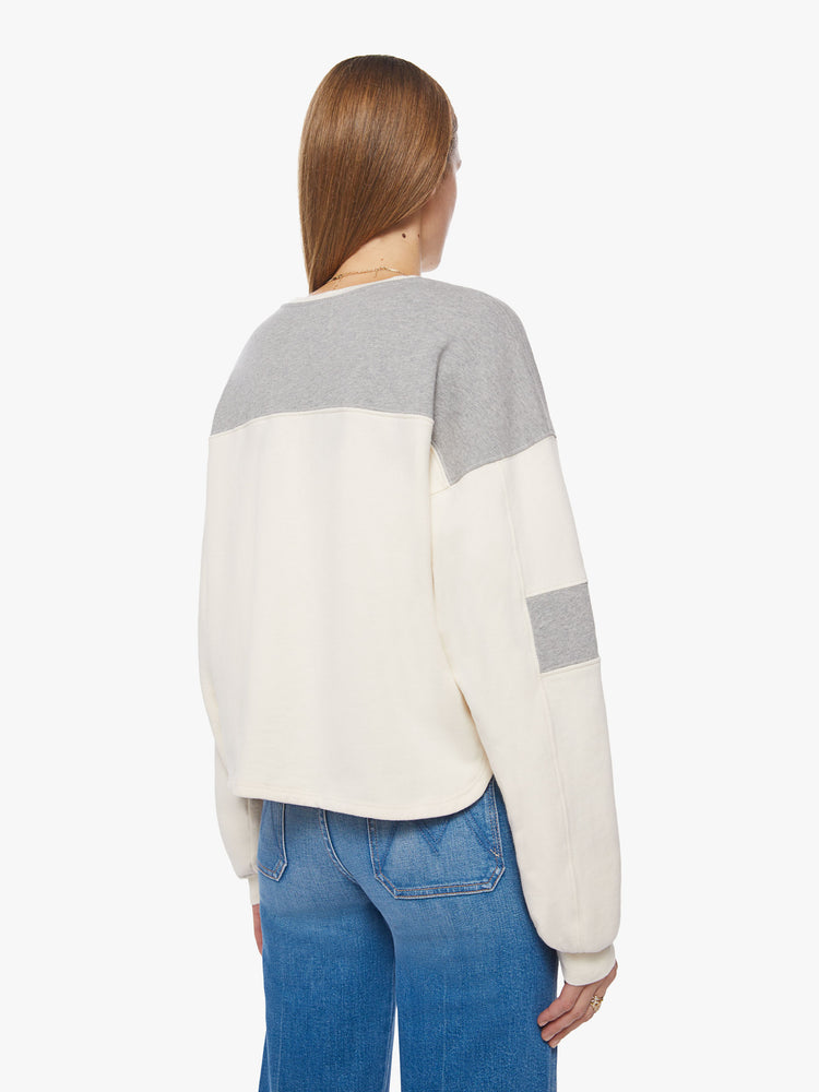 Back view of an off-white and grey details crewneck pullover with drop shoulders, long loose sleeves, a slightly cropped hem and a boxy fit.
