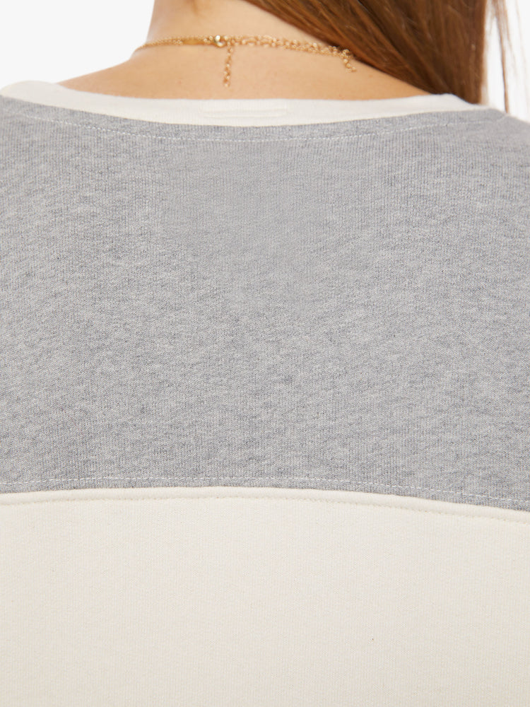 Back close up view of an off-white and grey details crewneck pullover with drop shoulders, long loose sleeves, a slightly cropped hem and a boxy fit.