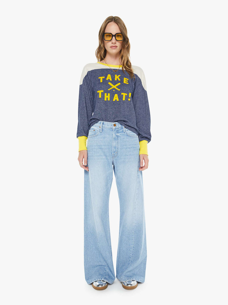 Full body view of a woman in a navy  long-sleeve top with a crew neck, boxy fit and extra-long ribbing at the wrists