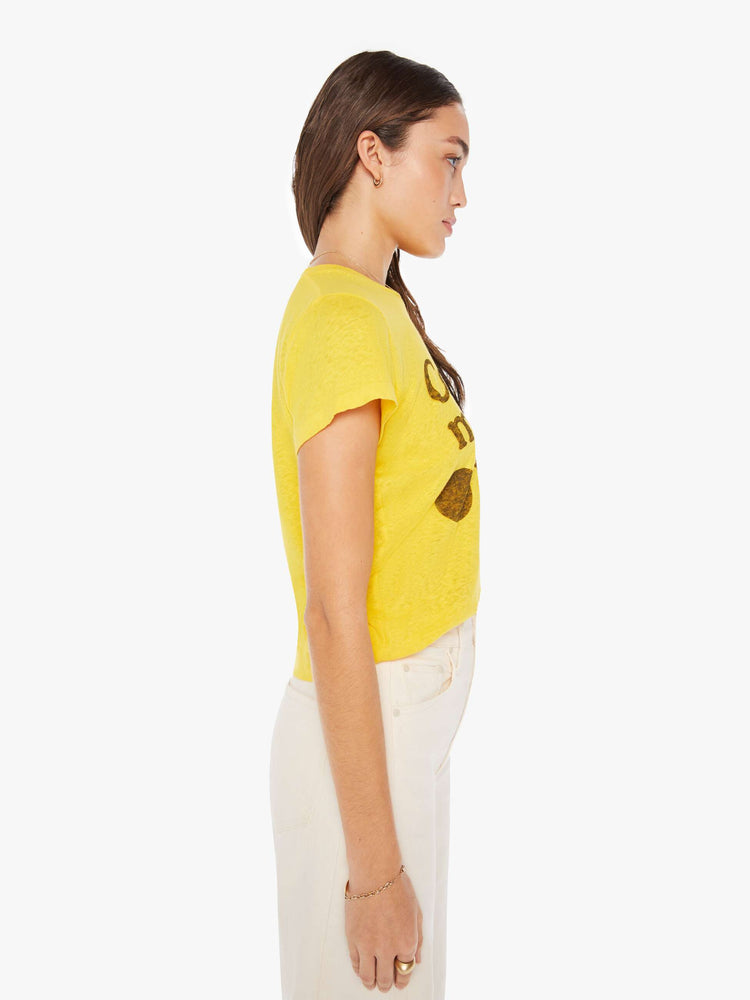 Side view of a woman in yellow crewneck with a slim fit for a vintage look with shapes on the front.