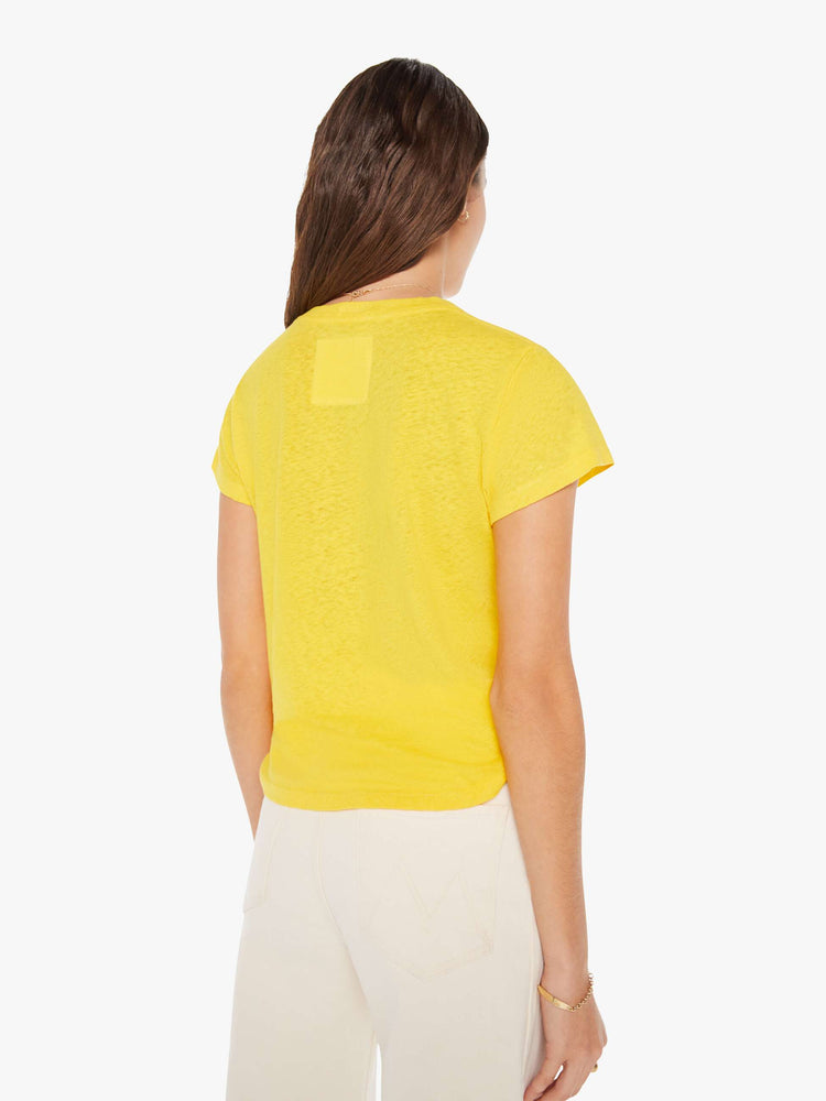 Back view of a woman in yellow crewneck with a slim fit for a vintage look with shapes on the front.