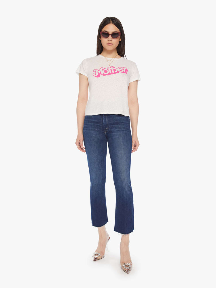 Full body view of a woman white soft crewneck with a slim fit in white with the words MOTHER in pink.