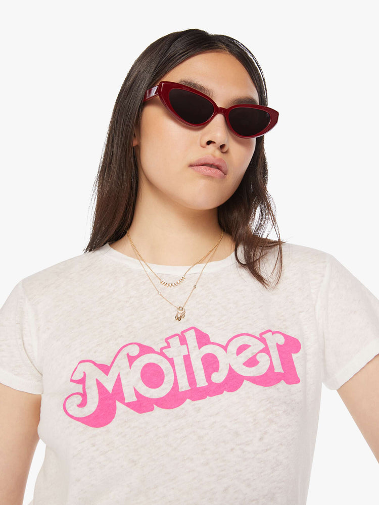 Close up view of a woman white soft crewneck with a slim fit in white with the words MOTHER in pink.