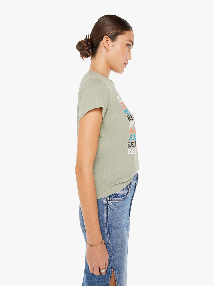 Side view of a faded green crew neck tee featuring a colorful graphic.