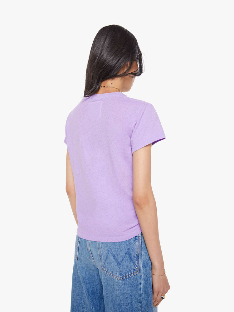 Back view of a woman in a slim fit lavender tee with white faded graphic.