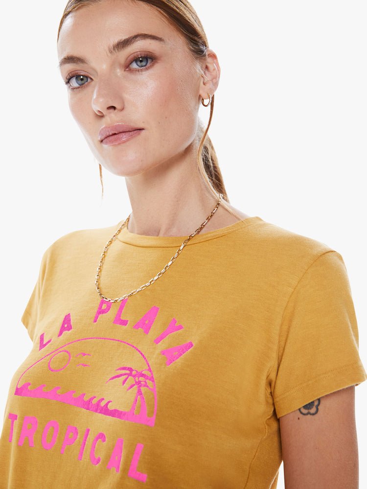 Close up view of a woman crewneck with a slim fit in a yellow hue, the tee features a tropical hot pink graphic with text on the front.