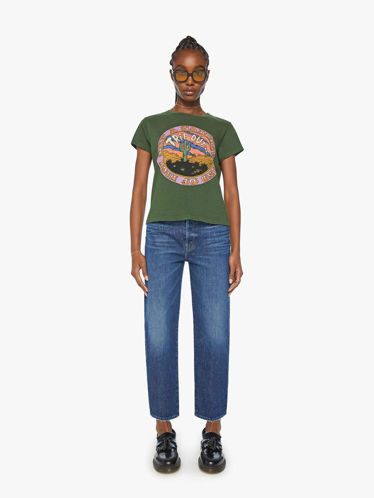 Full body  view of a woman forest green tee features a national park-inspired desert graphic with text on the front.