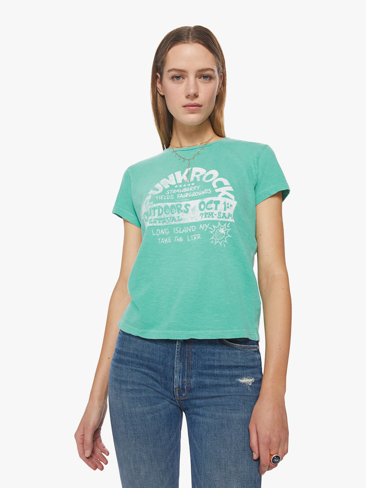Front view of a woman washed green tee hue features a faded concert flyer-inspired graphic in white on the chest.