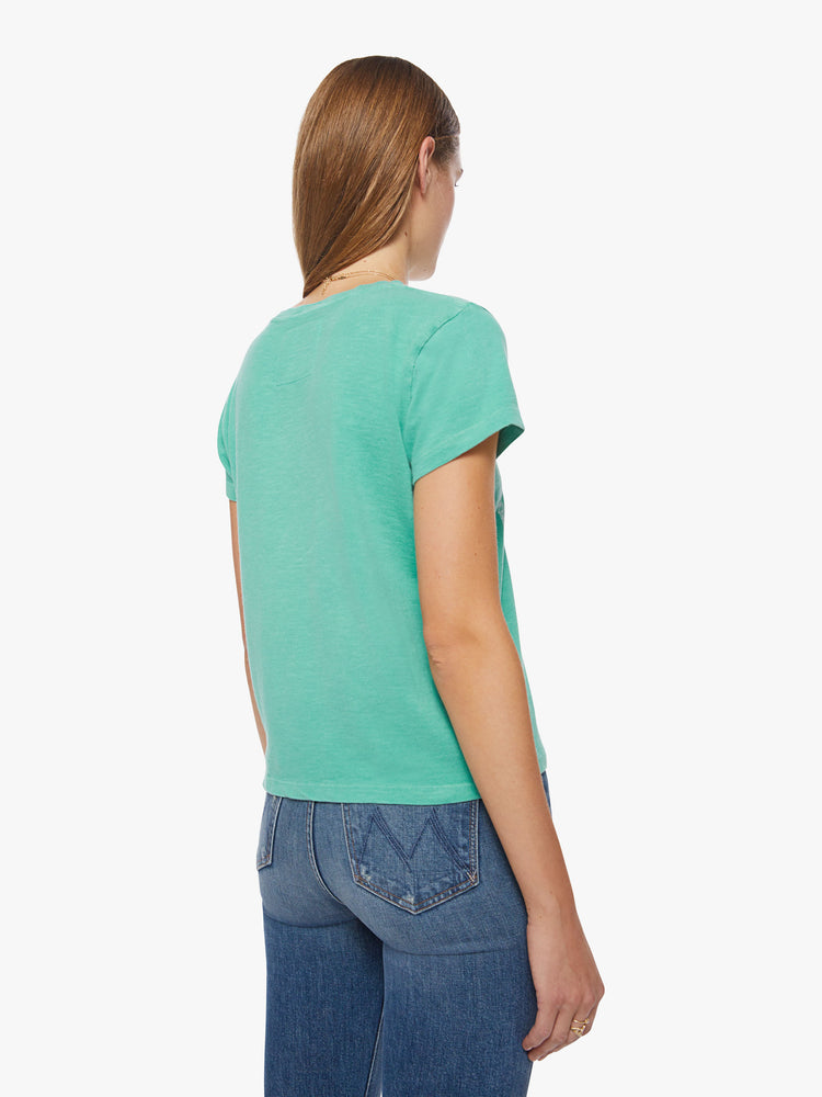 Back view of a woman washed green tee hue features a faded concert flyer-inspired graphic in white on the chest.