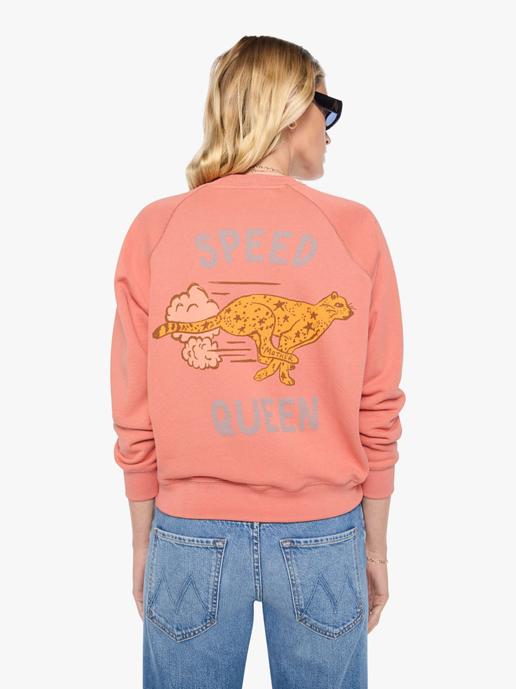 Back view of a woman  pale pink cardigan features a cream button panel and a golden tiger graphic on the back, and MOTHER's name in light blue on the chest.