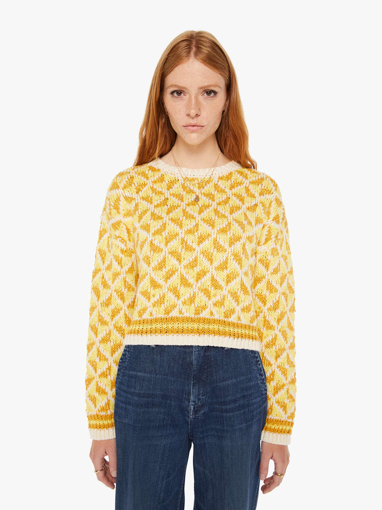 Front view of a womens knit sweater featuring a yellow gemetric pattern.