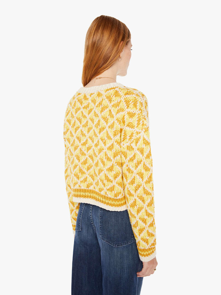 Back view of a womens knit sweater featuring a yellow gemetric pattern.