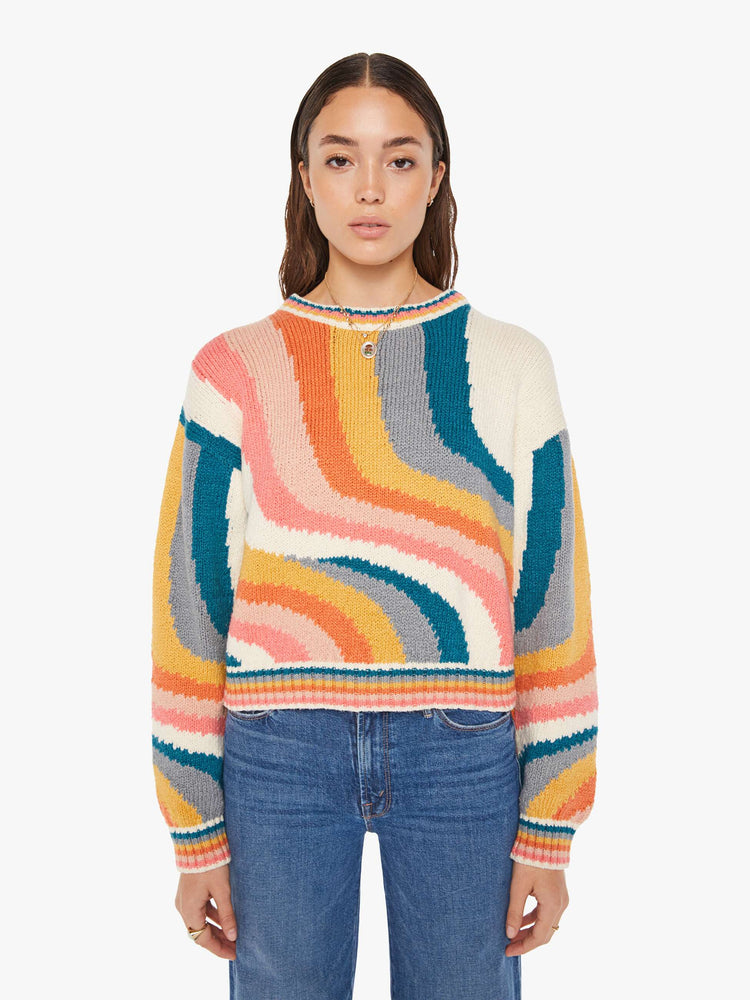 Front view of a womens knit sweater featuring a boxy fit and a wavy multi color pattern.