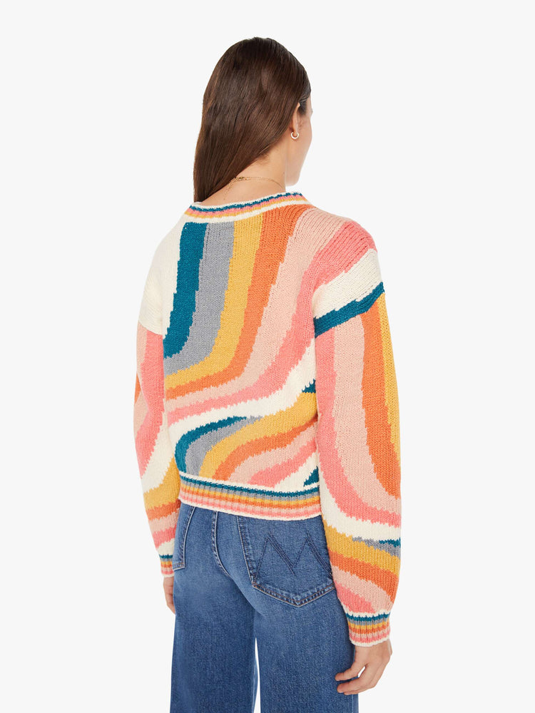 Back view of a womens knit sweater featuring a boxy fit and a wavy multi color pattern.
