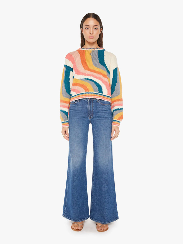 Front full body view of a womens knit sweater featuring a boxy fit and a wavy multi color pattern.