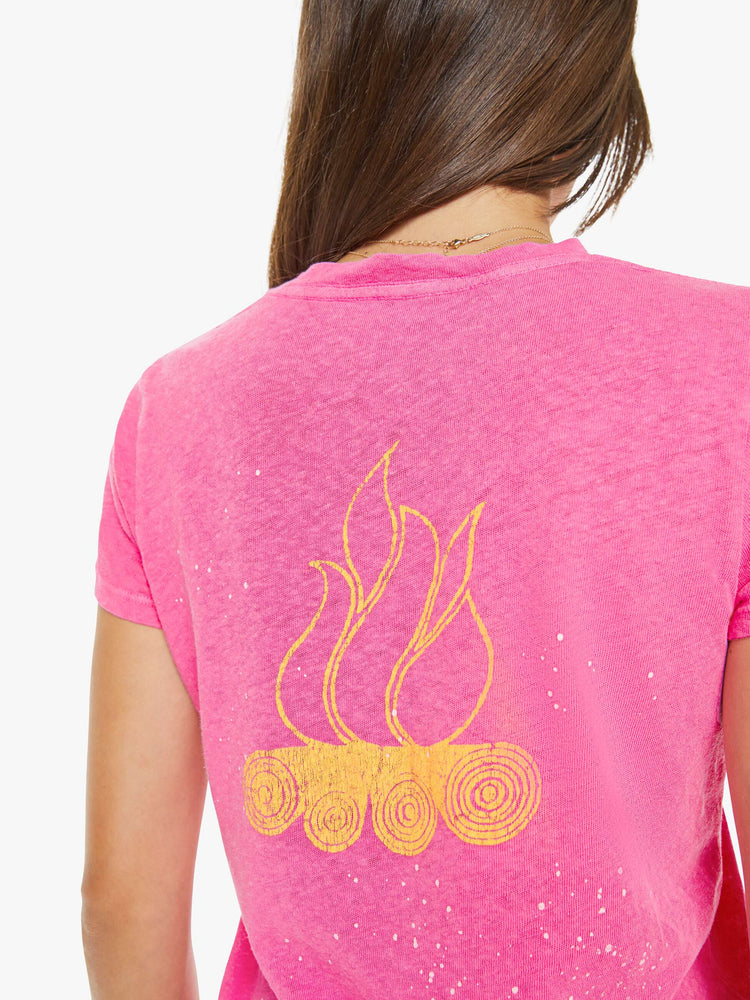 Back close up view of a woman in a pink with white paint splatters and a sun graphic on the front that reads "Day Camp."