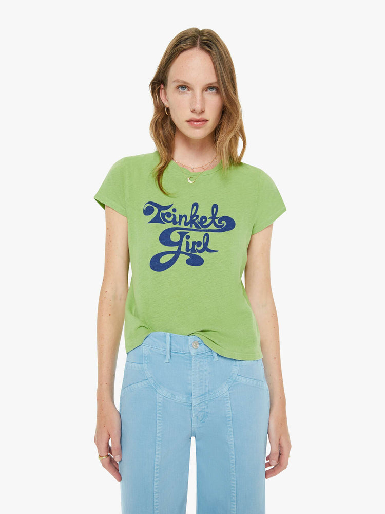 Front view of a woman in a tee is designed in green with a blue text graphic on the front that reads "Trinket Girl."