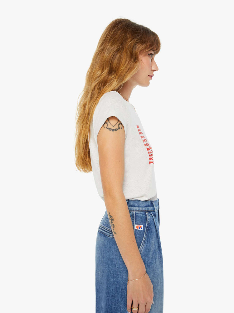 Side view of a woman slim fit white tee with a red text graphic on the front.