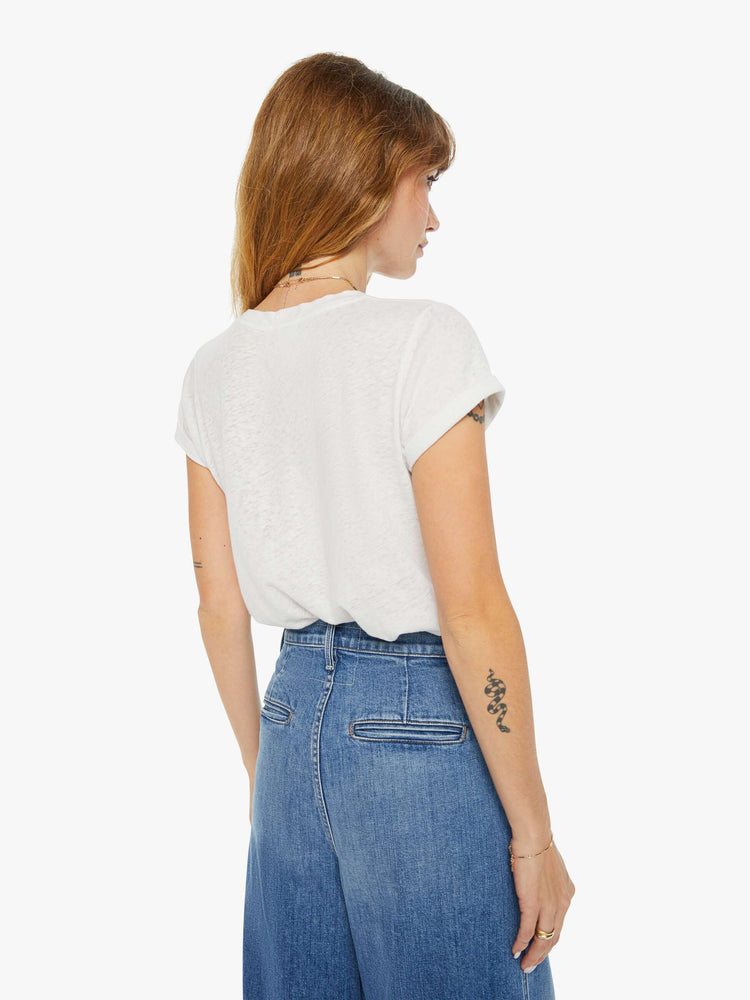 Back view of a woman slim fit white tee with a red text graphic on the front.