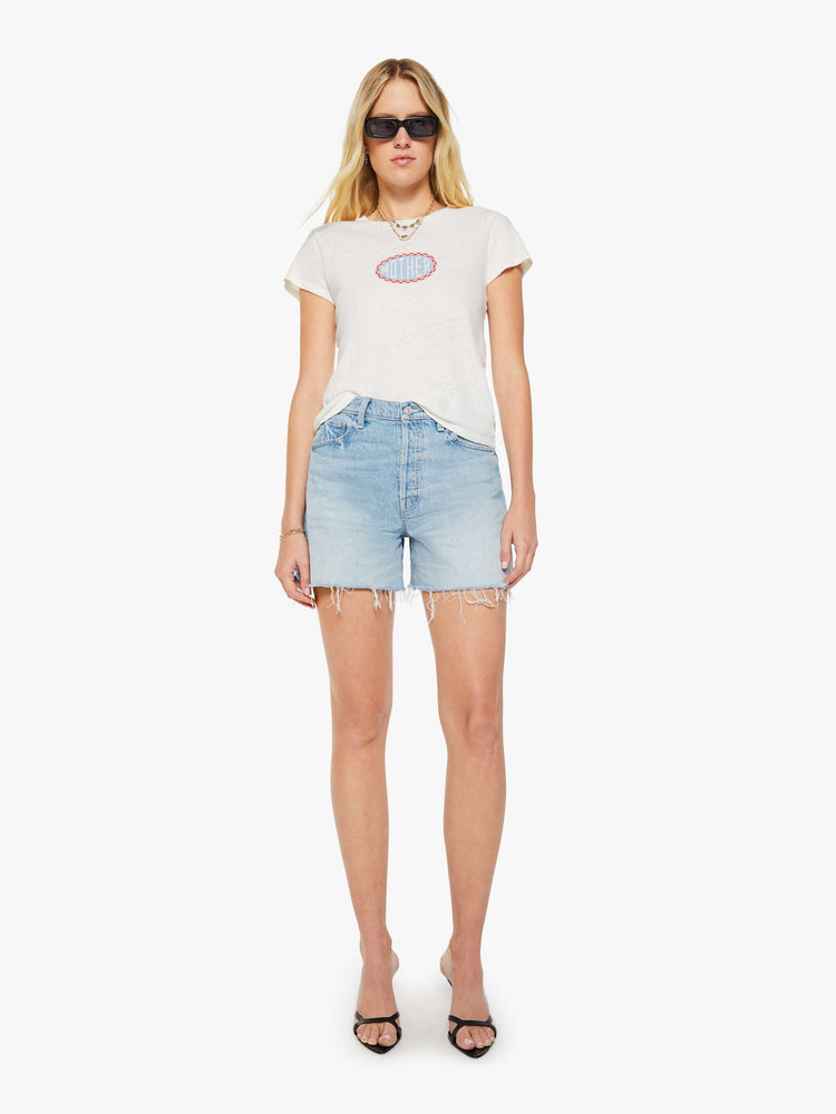 Full body view of a woman in a white tee with a light blue and red graphic and MOTHER's name on the front.