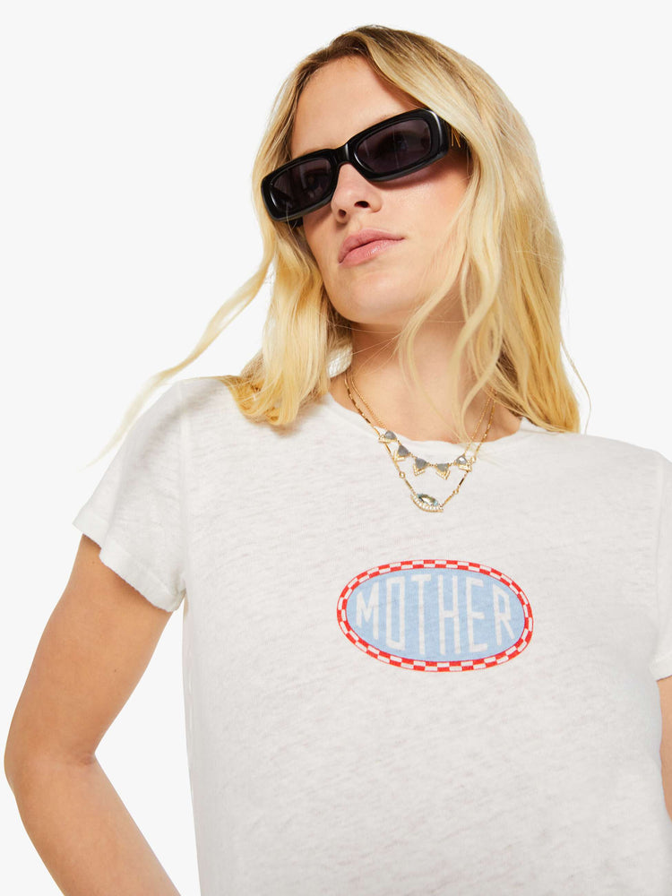 Close up view of a woman in a white tee with a light blue and red graphic and MOTHER's name on the front.