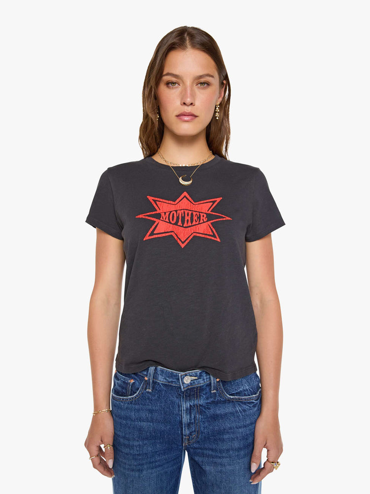 Front view of a woman in a faded black tee with MOTHER's name in a coral crackle-printed starburst graphic on the front.