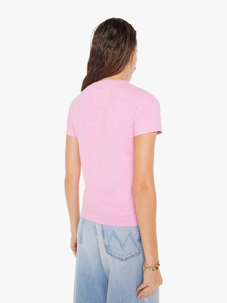 Back view of a woman wearing a fitted pink crew neck tee, paired with a light blue wash jean.