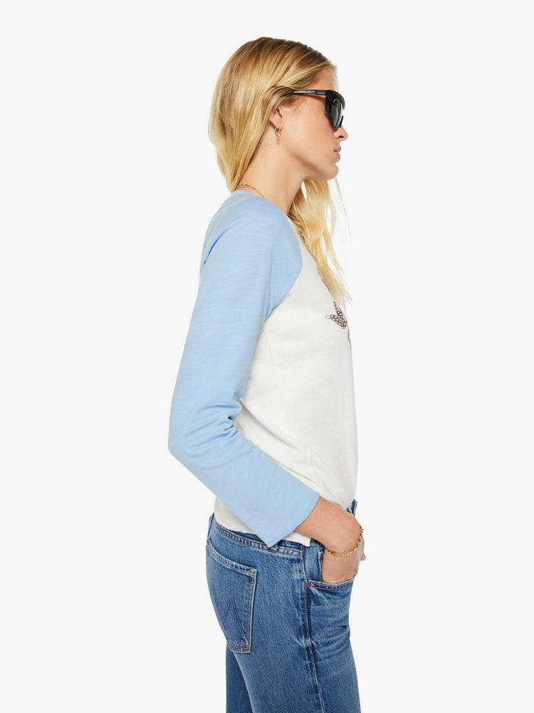 Side view of a woman in a vintage-inspired concert tee is designed with a crewneck, long sleeves, side slits and a relaxed fit. 