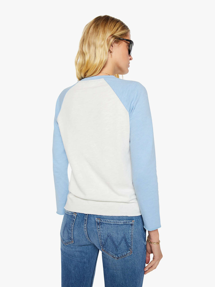Back view of a woman in a vintage-inspired concert tee is designed with a crewneck, long sleeves, side slits and a relaxed fit. 